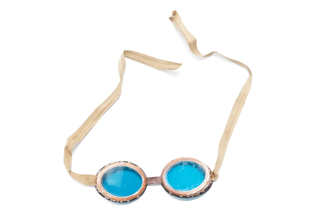 Two pairs of WW2 desert goggles, blue tinted lenses, one with original tin box